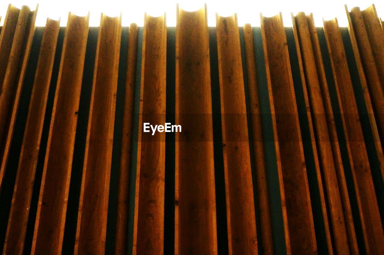 LOW ANGLE VIEW OF CURTAIN IN FRONT OF BUILT STRUCTURE