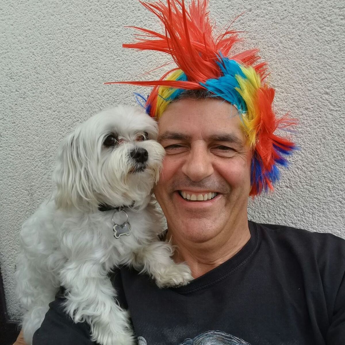 PORTRAIT OF SMILING MAN WITH DOG OUTDOORS