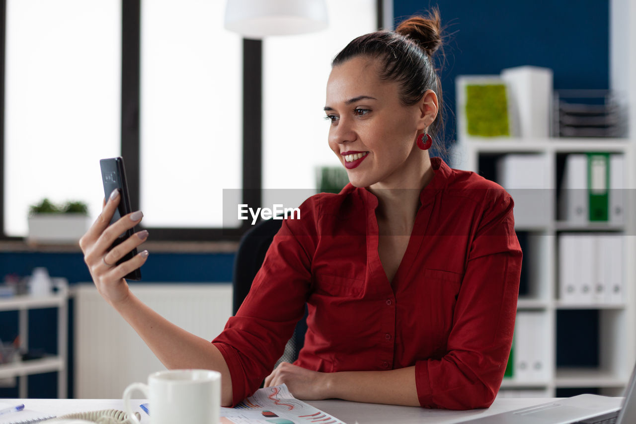 Businesswoman talking on video call at office