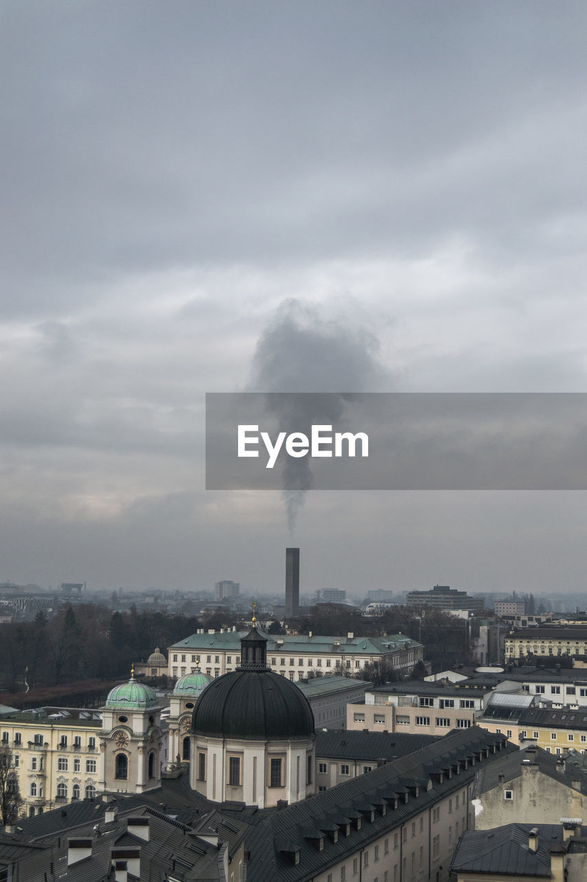 High angle view of factory against cloudy sky