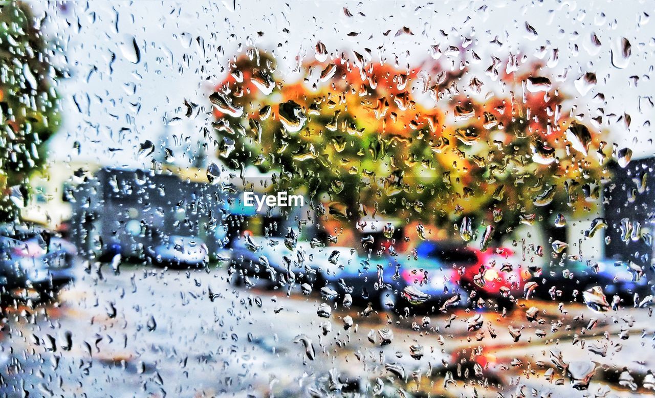 CLOSE-UP OF WET CAR WINDOW AGAINST SKY