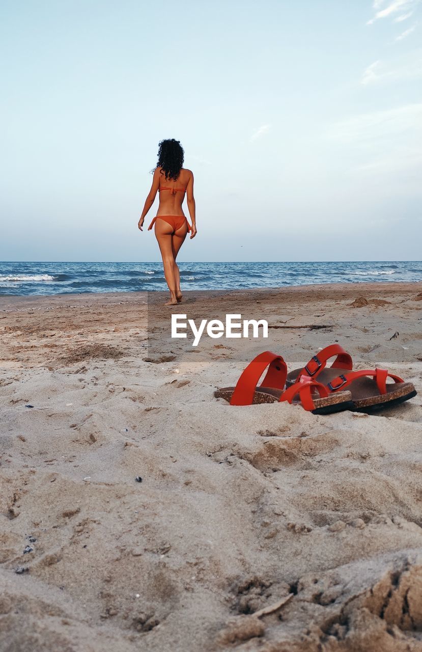 Full length of beautiful womand in bikini  standing on beach