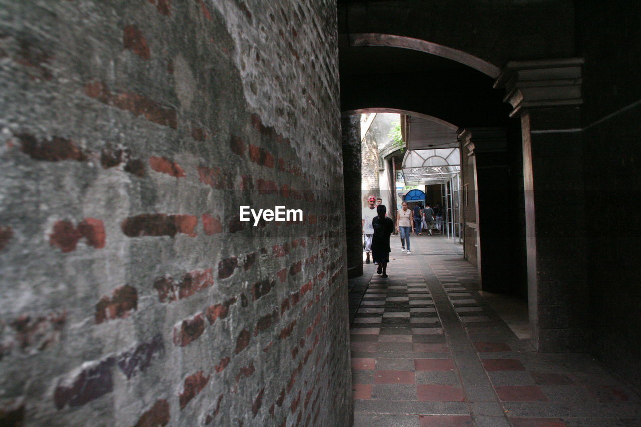 MAN STANDING IN TUNNEL