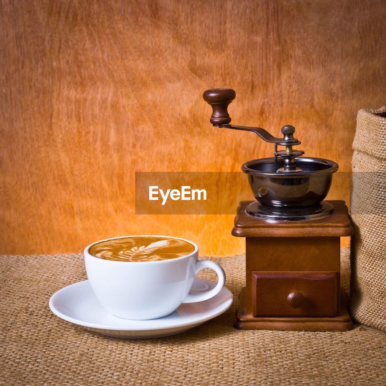 Close-up of coffee by grinder on table