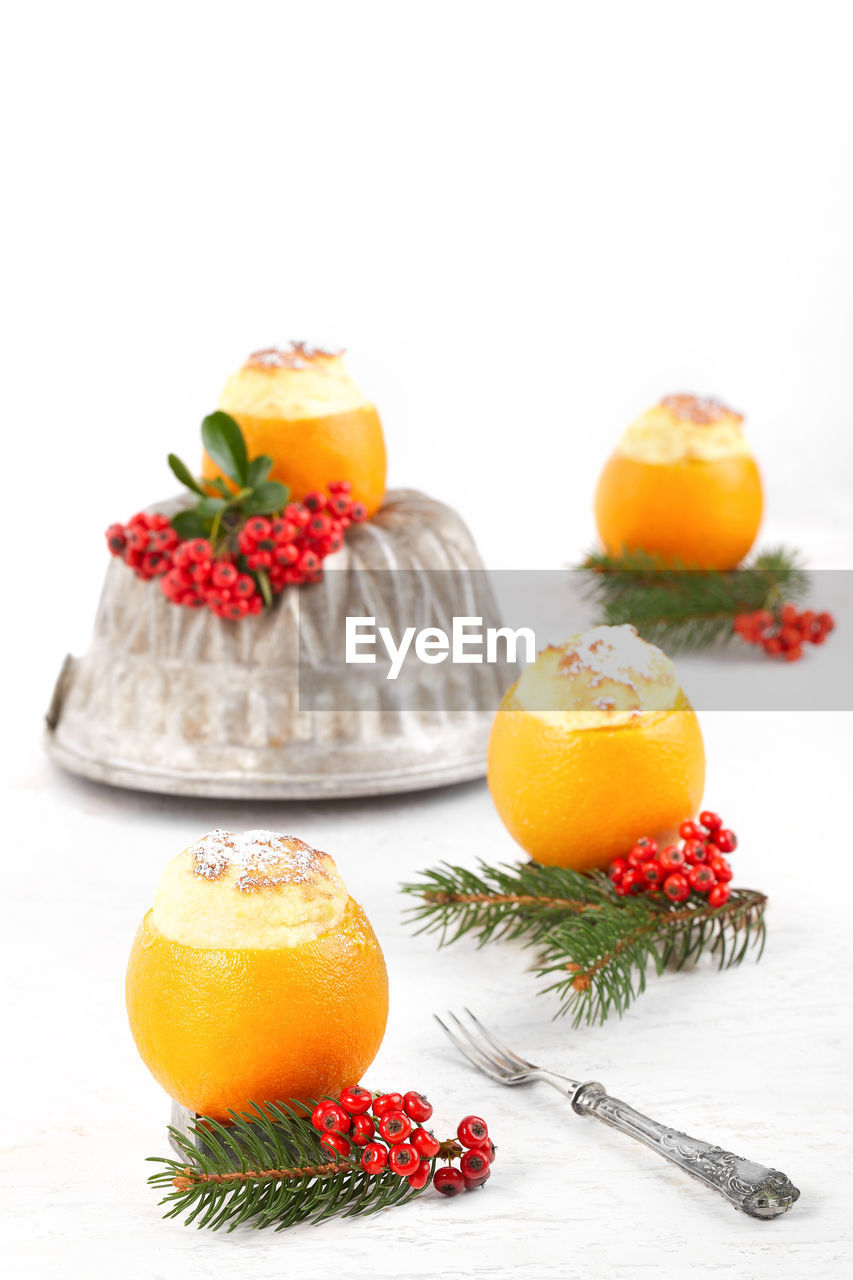 Orange fruits and christmas decorations on white background