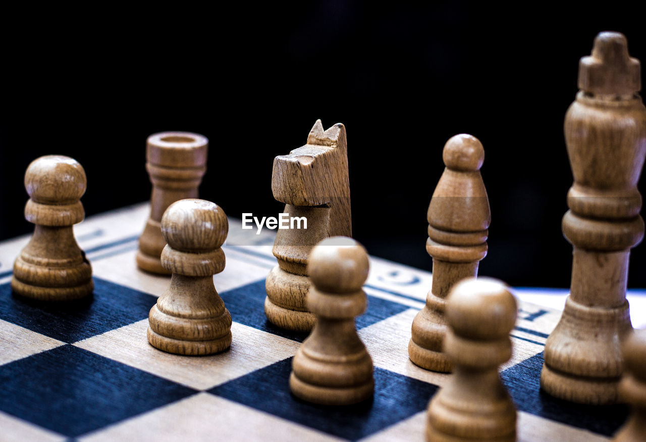 Close-up of chess board against black background