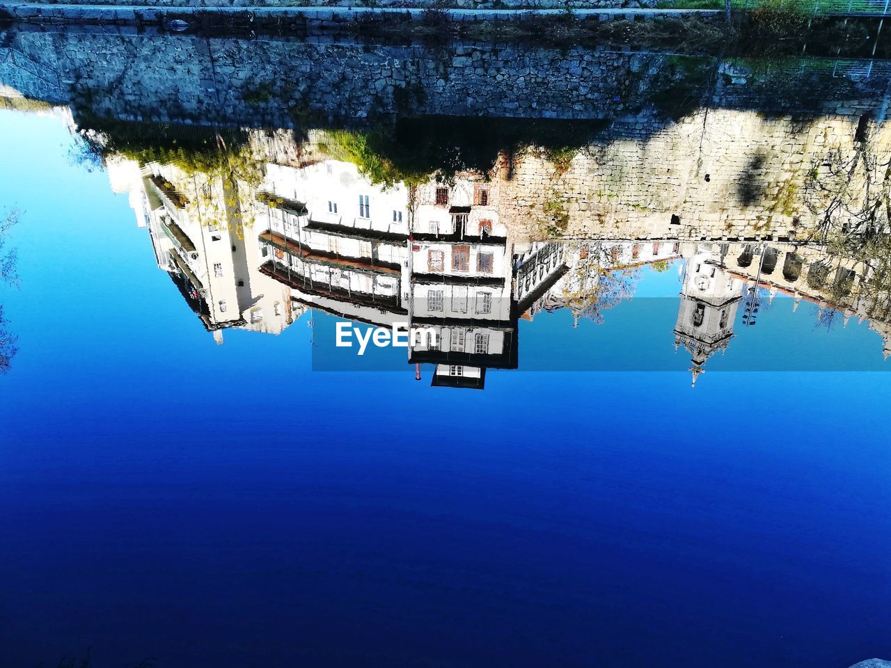 REFLECTION OF BUILDING IN LAKE