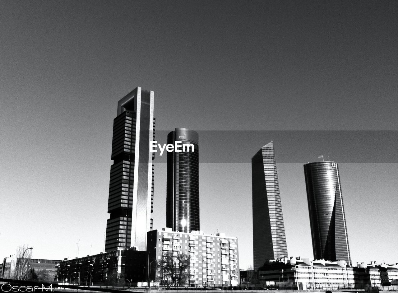 LOW ANGLE VIEW OF MODERN BUILDINGS AGAINST CLEAR SKY