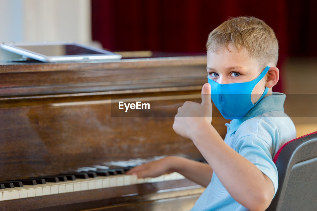 Portrait of boy playing piano