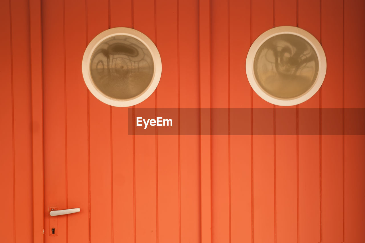 Full frame shot of orange locked ship door