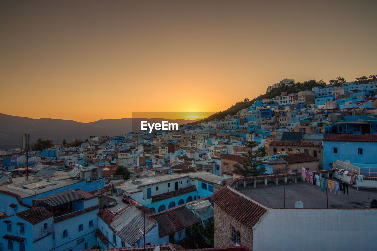 Elevated view of cityscape against sky at sunset