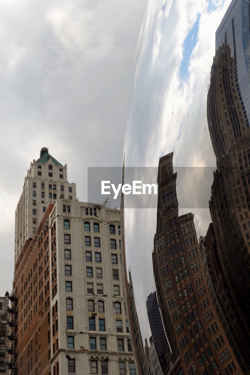 LOW ANGLE VIEW OF BUILDINGS IN CITY AGAINST SKY