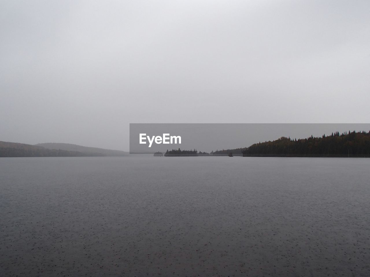 SCENIC VIEW OF FROZEN LAKE AGAINST CLEAR SKY
