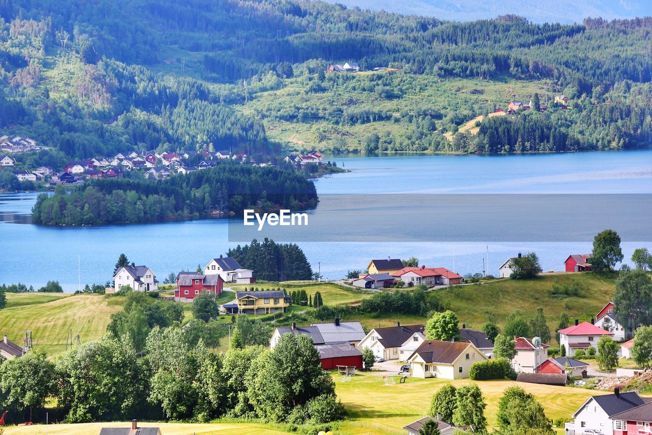 Scenic view of lake by trees and buildings