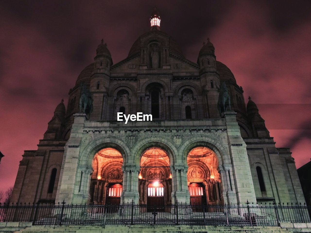 Low angle view of illuminated cathedral against sky at night