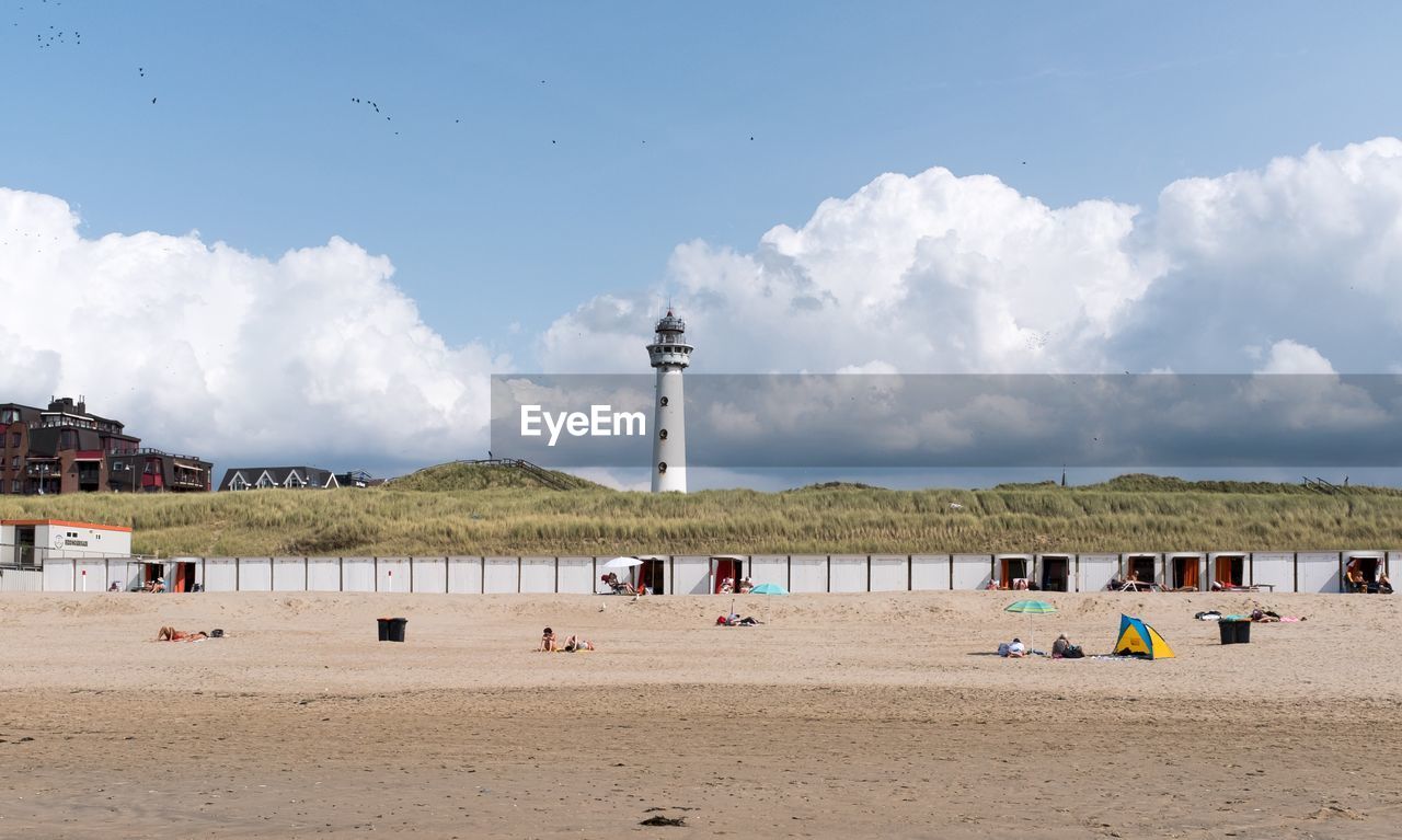 Scenic view of beach against cloudy sky