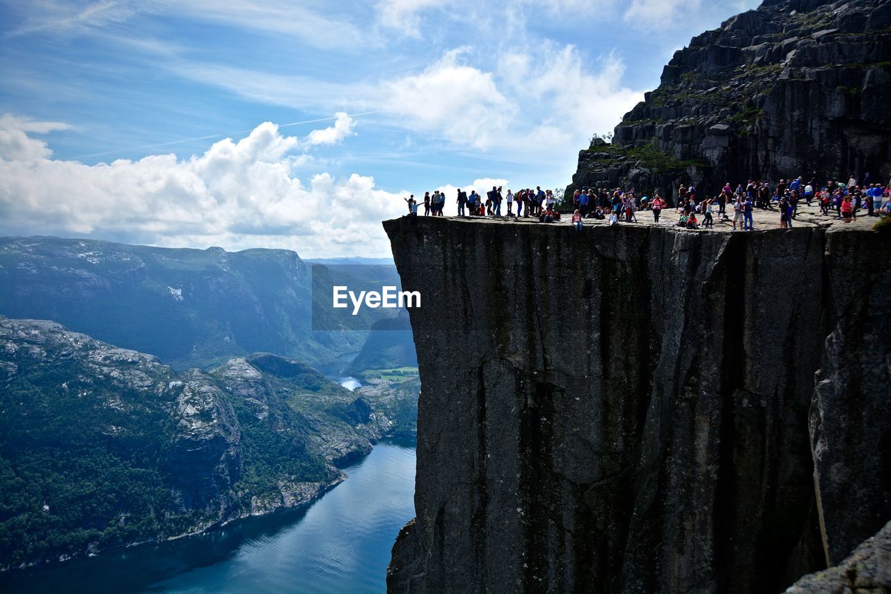 People at preikestolen against sky