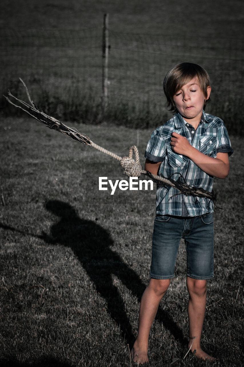 Boy standing on field