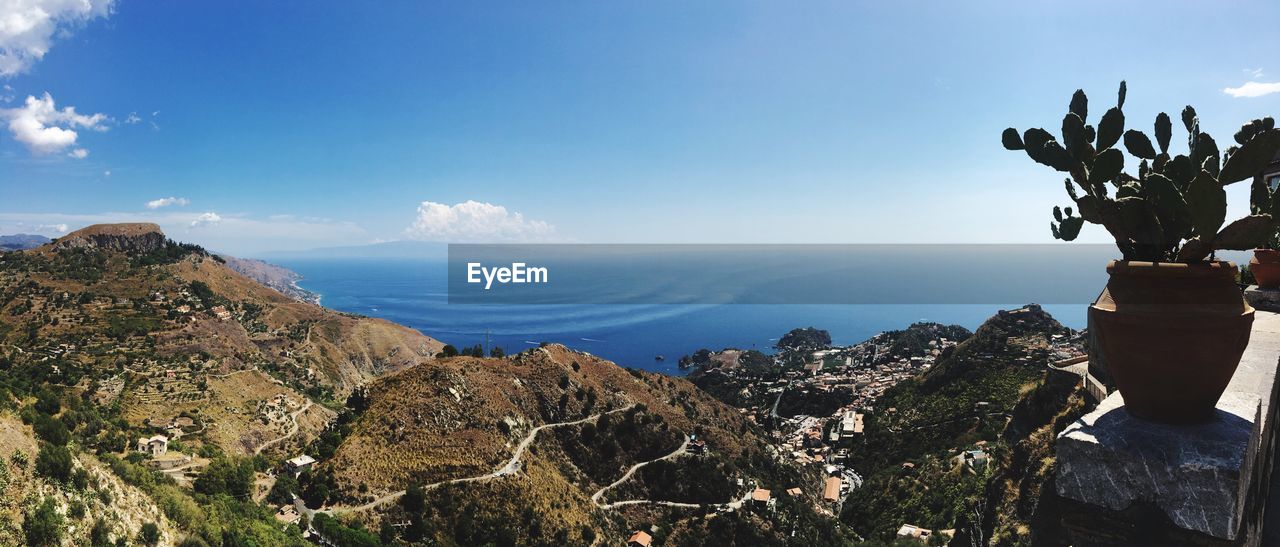 PANORAMIC VIEW OF STATUE AND MOUNTAINS AGAINST SKY