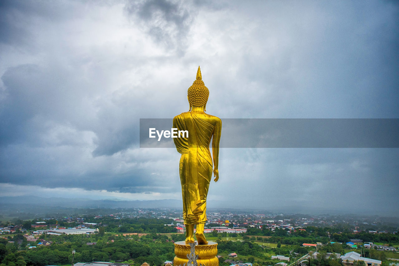 Buddha statue against cloudy sky