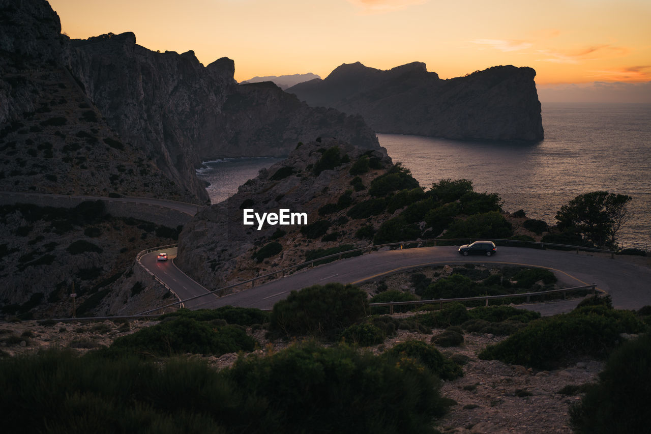 Scenic view of landscape against sky during sunset with cars. formentor, mallorca, spain. 