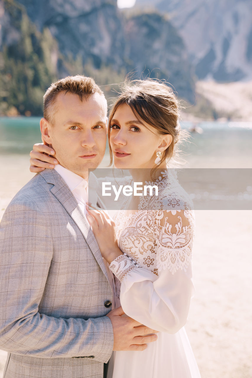 Portrait of bridegroom standing on beach