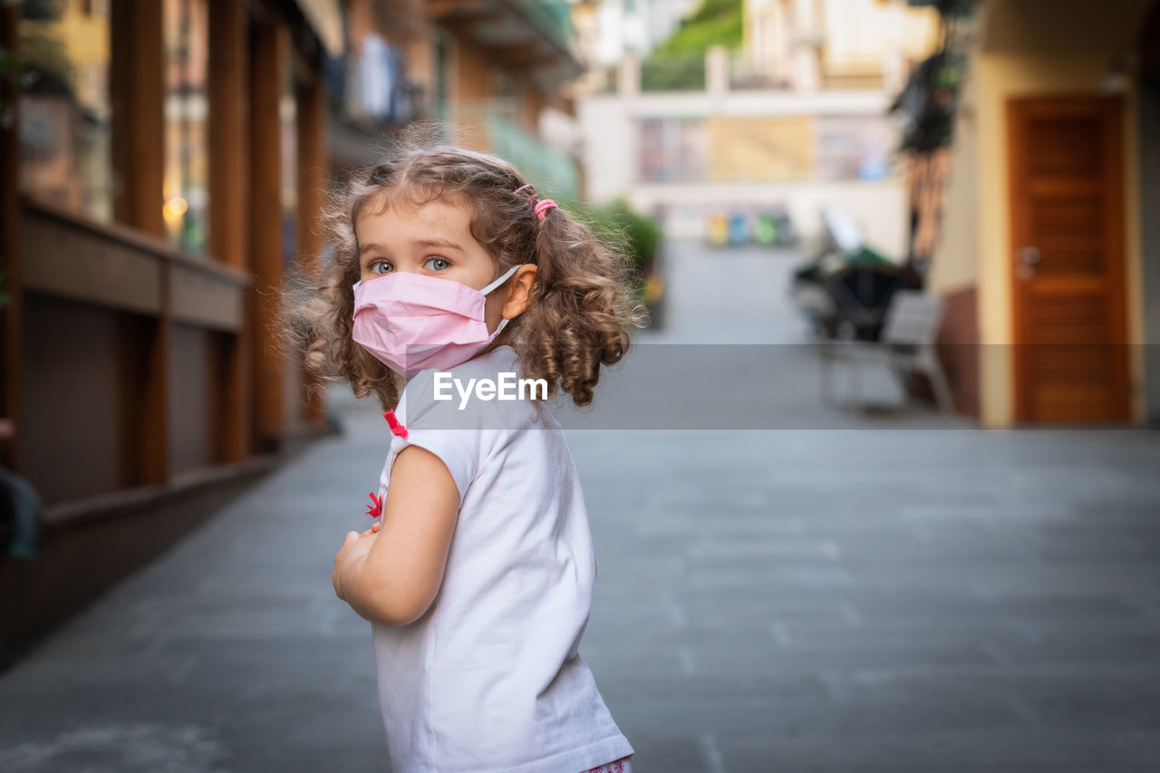 Portrait of cute girl standing on road