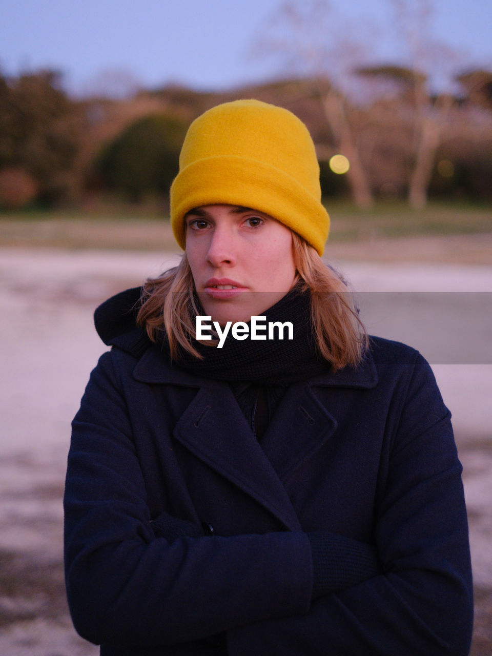 Portrait of young woman standing outdoors during winter