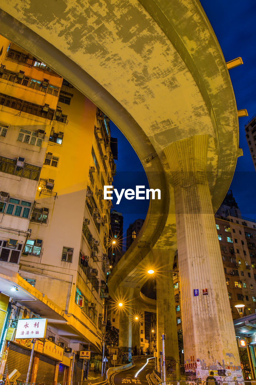 LOW ANGLE VIEW OF ILLUMINATED BUILDINGS AGAINST SKY