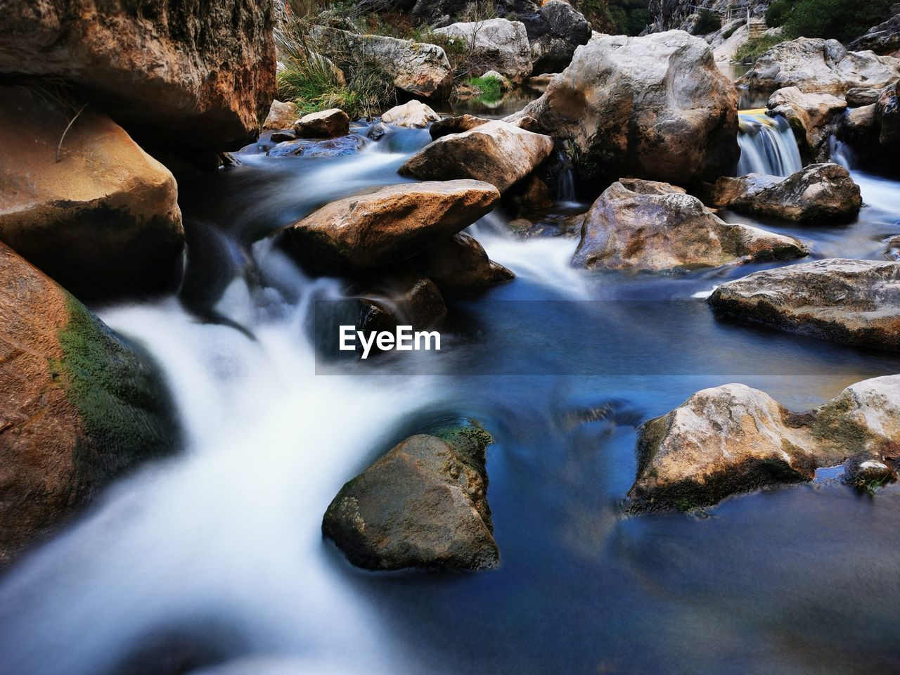 water, rock, nature, beauty in nature, body of water, stream, river, scenics - nature, rapid, watercourse, motion, landscape, land, autumn, long exposure, environment, wilderness, water feature, no people, creek, flowing water, forest, outdoors, waterfall, flowing, stream bed, plant, leaf, tranquility, non-urban scene, tree, blurred motion, idyllic, travel destinations, day, tranquil scene