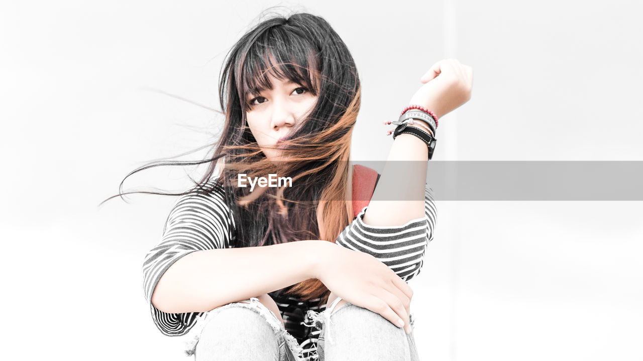 Portrait of young woman with tousled hair