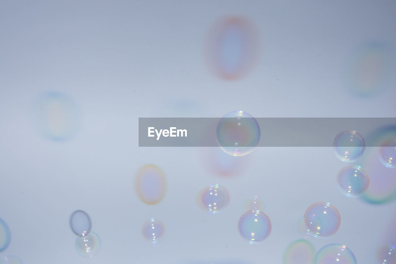 Close-up of bubbles over white background