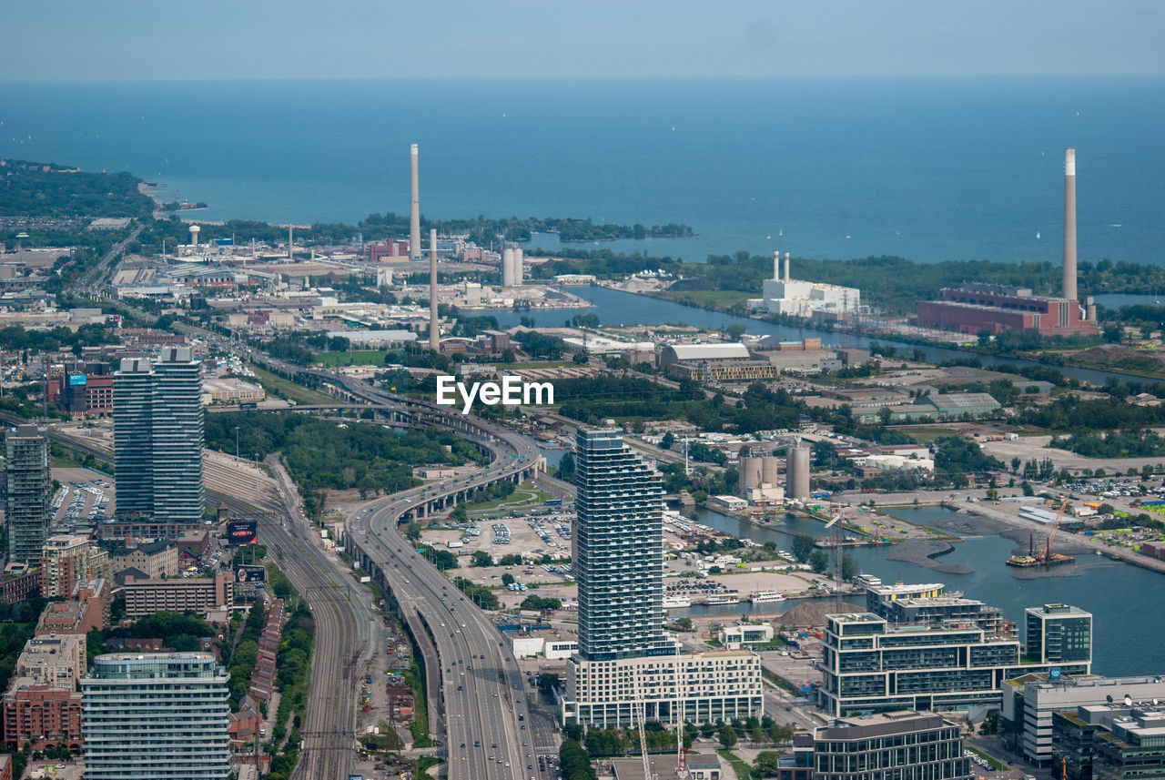 High angle view of buildings and sea against sky