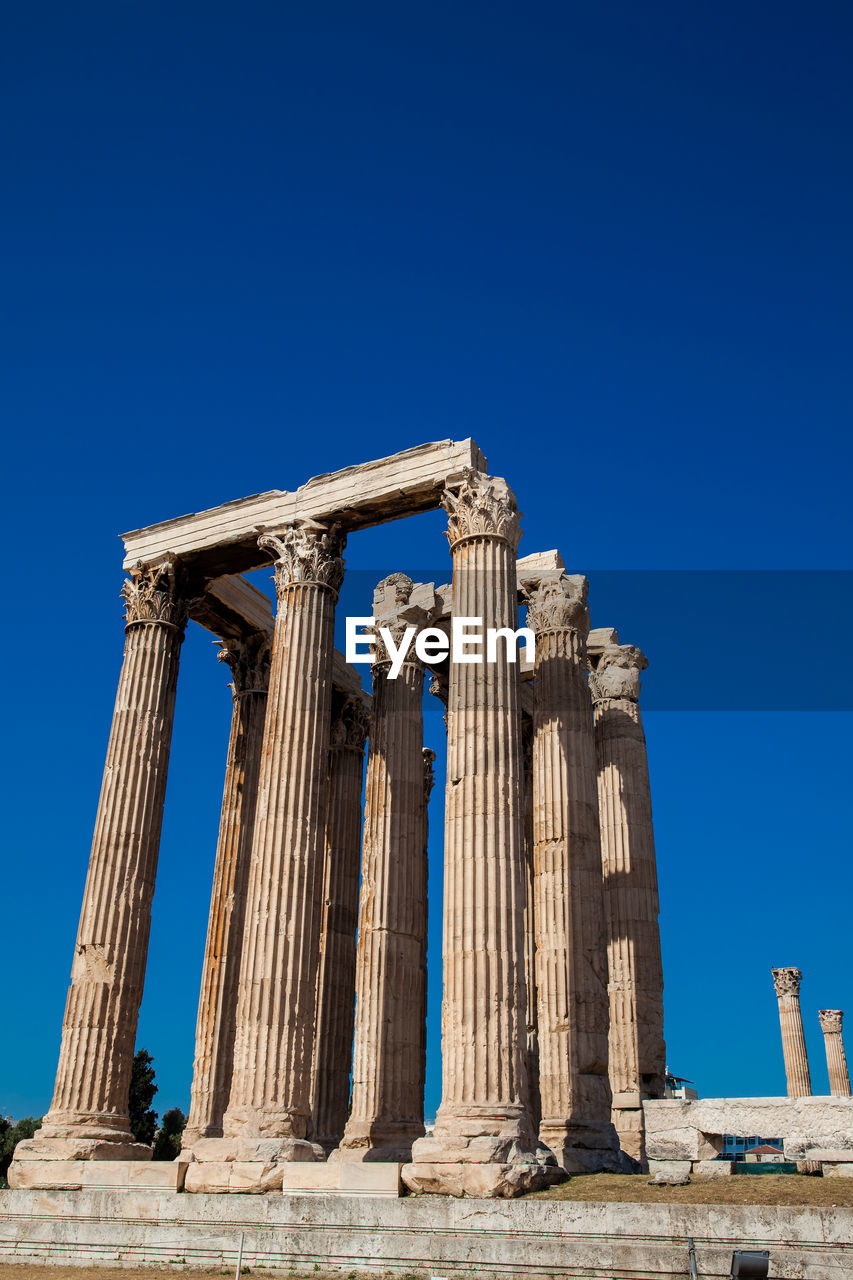 Ruins of the temple of olympian zeus also known as the olympieion and the acropolis in athens 