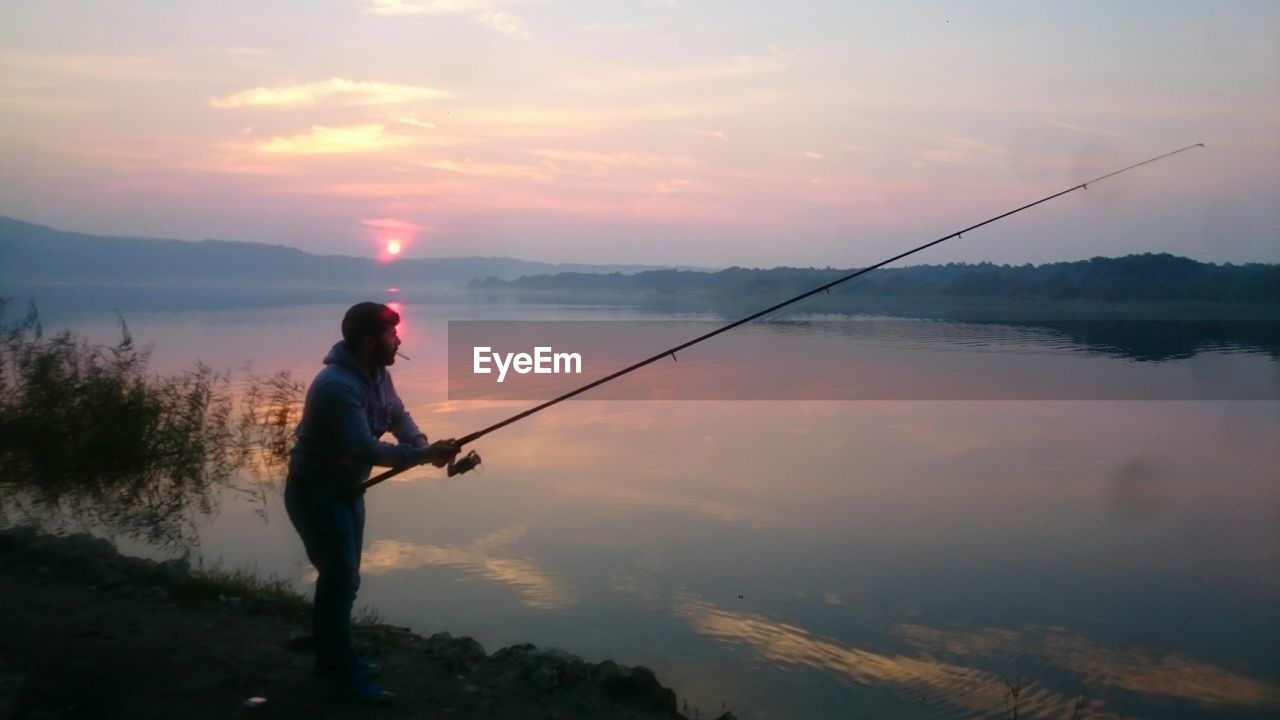 Man fishing at sunrise