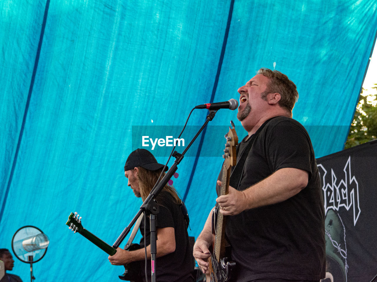 MEN HOLDING UMBRELLA ON STAGE