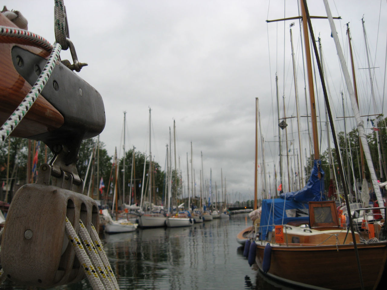 SAILBOATS MOORED AT HARBOR