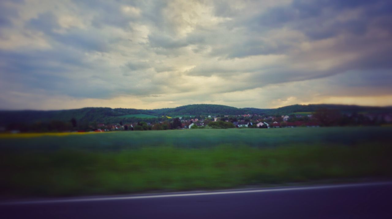 SCENIC VIEW OF MOUNTAINS AGAINST CLOUDY SKY