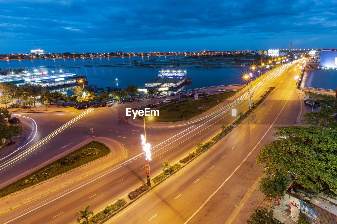 High angle view of light trails on highway in city at night