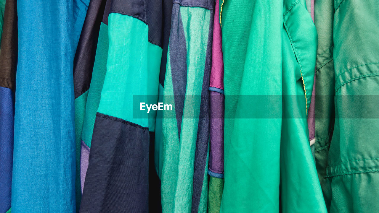 Full frame shot of multi colored clothes hanging in store for sale