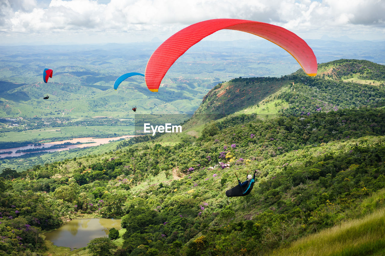 PEOPLE FLYING ABOVE LANDSCAPE