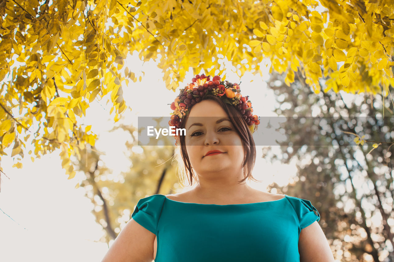 Portrait of beautiful young woman standing outdoors