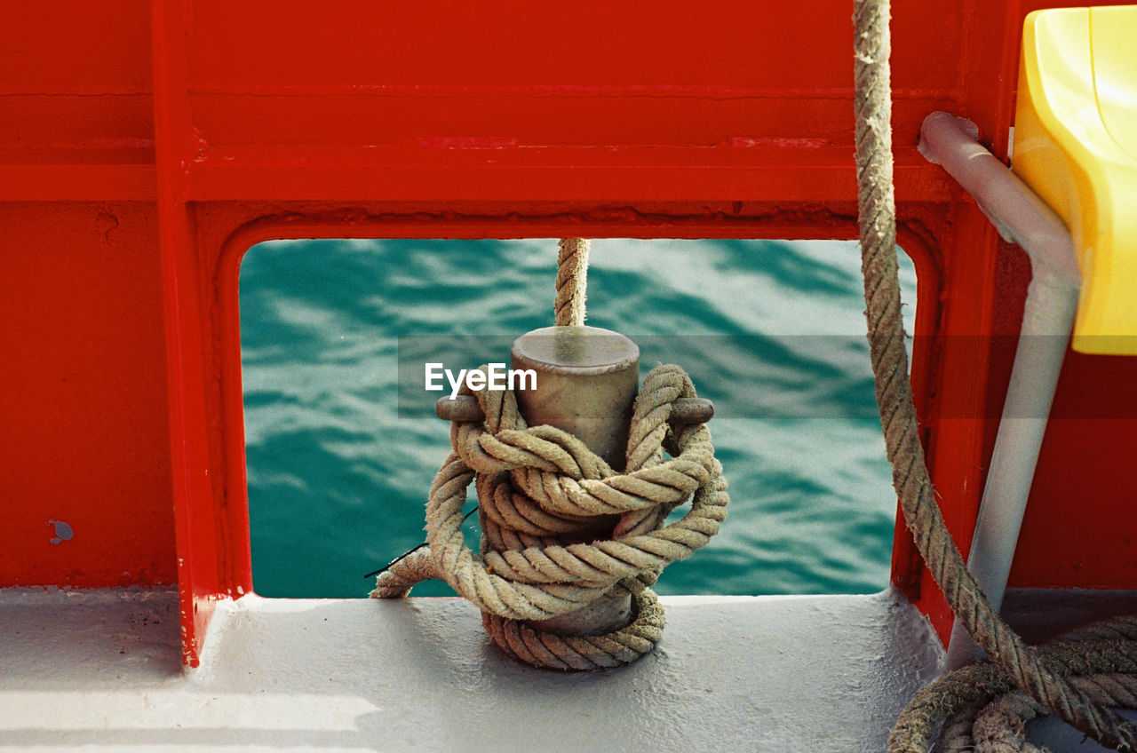 High angle view of rope tied up to cleat on boat 