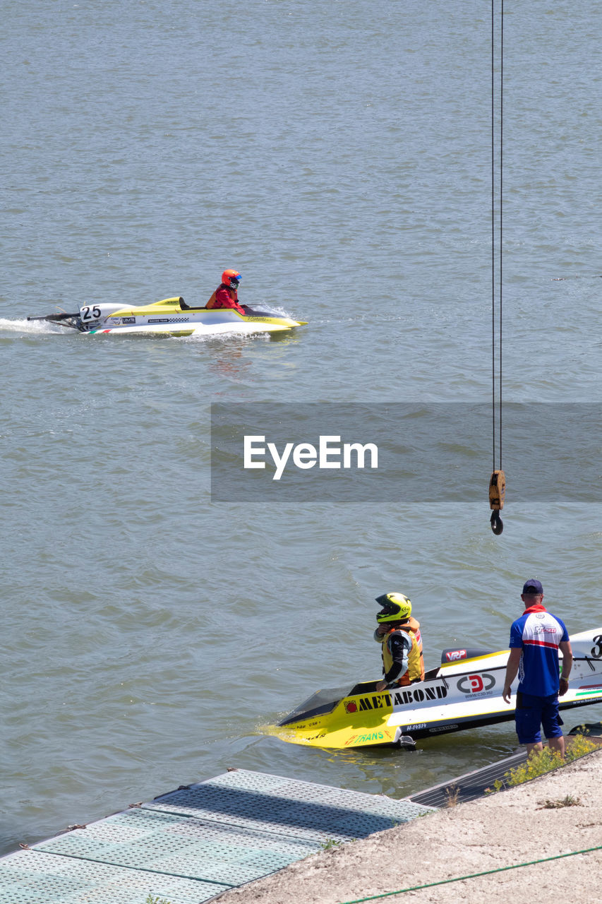 PEOPLE IN BOAT AT SEA