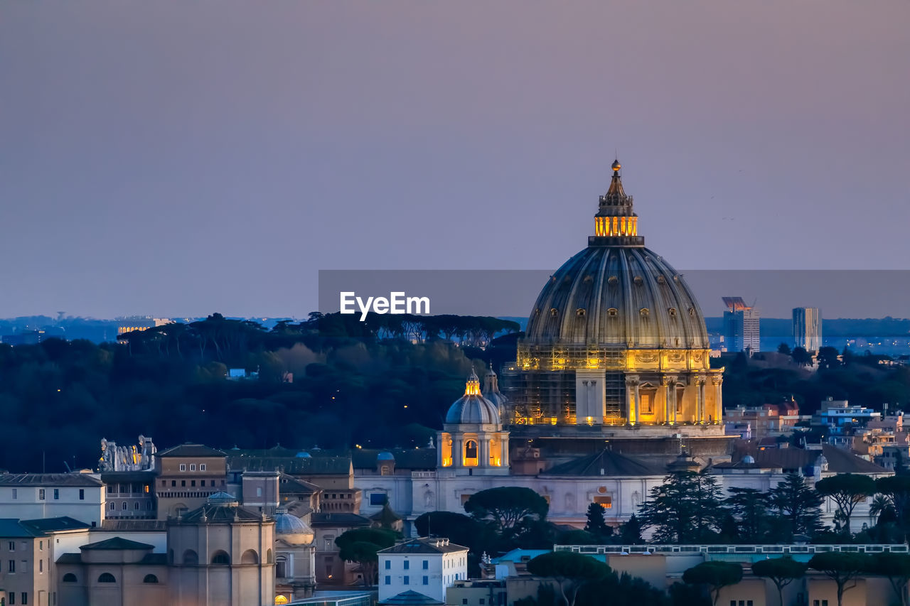 The skyline of the city of rome with st. peter's basilica, panoramic view among the pine trees.
