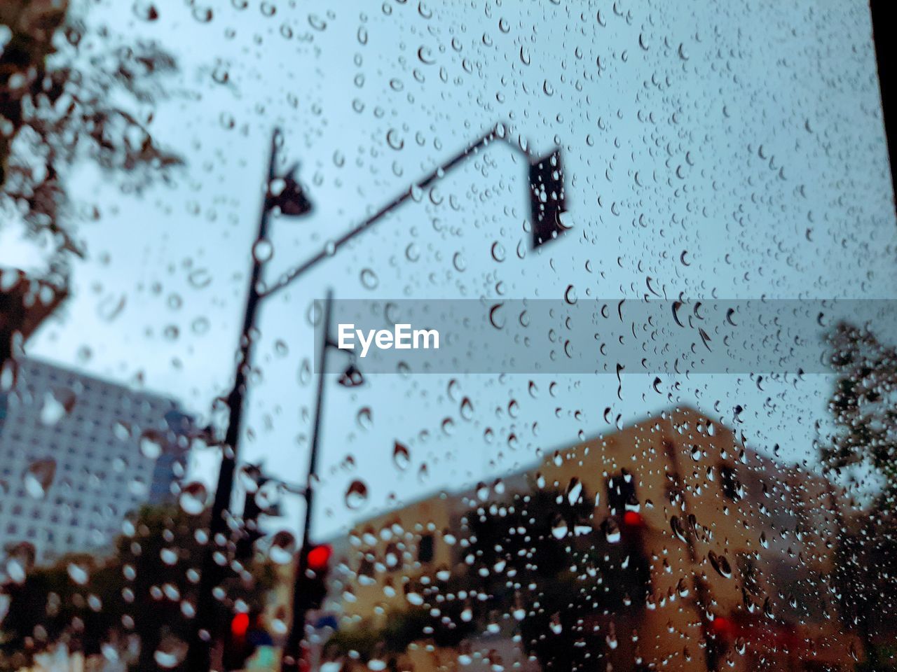 CLOSE-UP OF WET GLASS WINDOW DURING RAINY SEASON