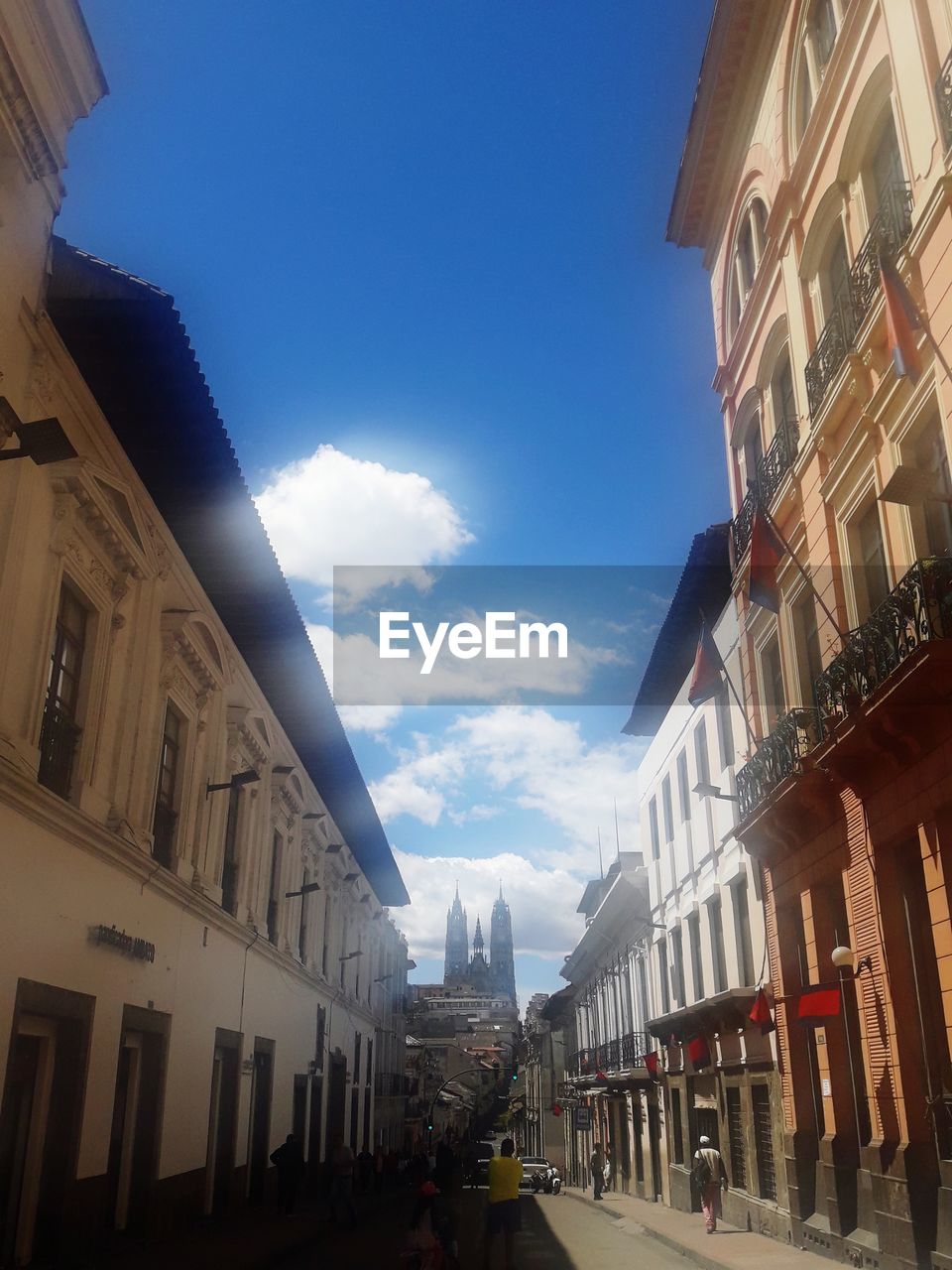 LOW ANGLE VIEW OF BUILDINGS BY STREET AGAINST SKY