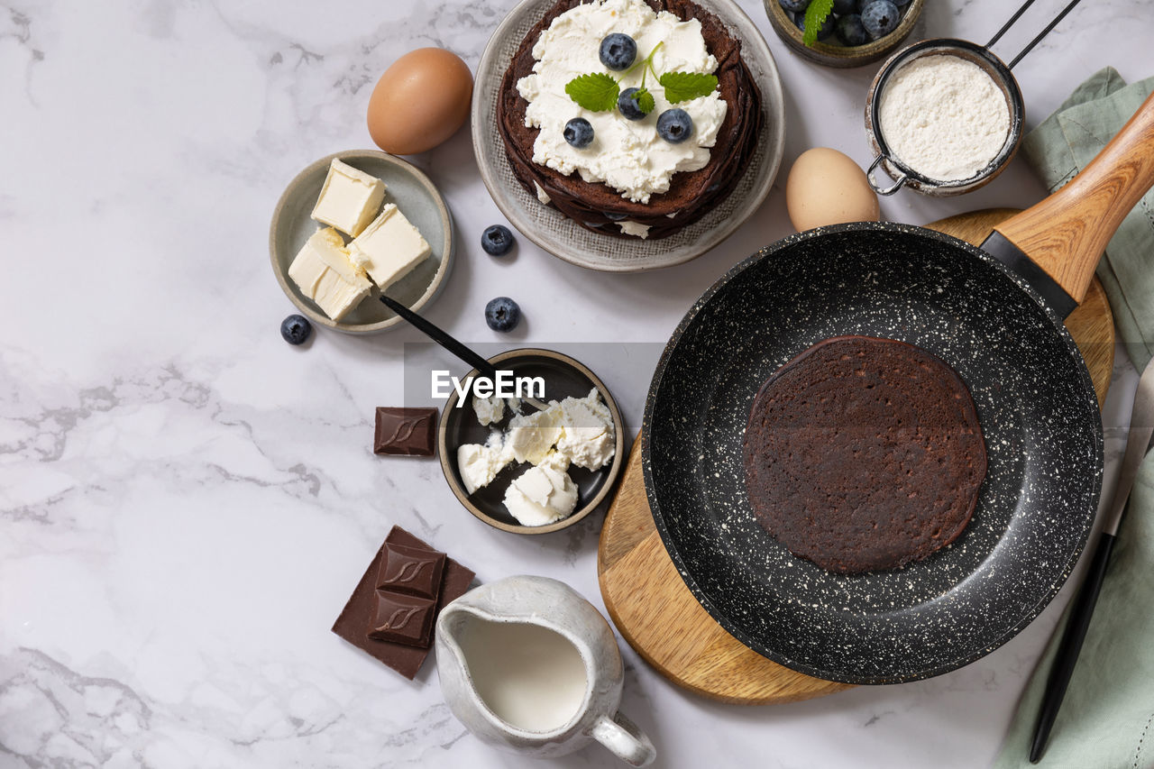 Ingredients for cooking and delicious crepes with blueberries and ricotta 