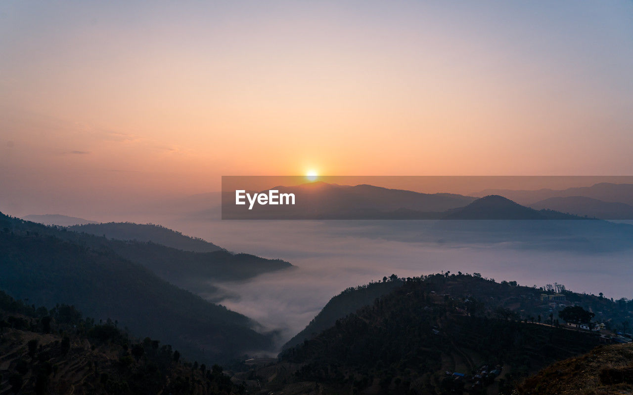 scenic view of mountains during sunset