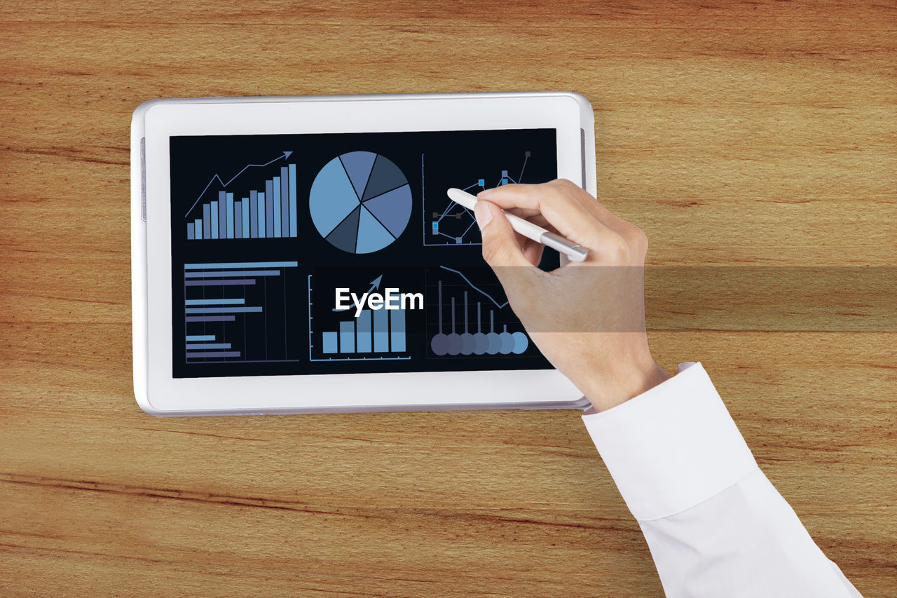 Cropped image of businessman using digital tablet with stylus on desk